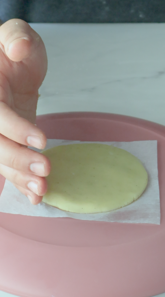 3. Form dough into round balls and flatter into perfect circles.